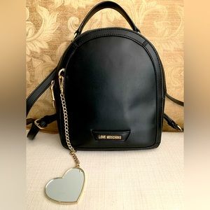 Love Moschino Black Vegan Leather Backpack with heart shape mirror.